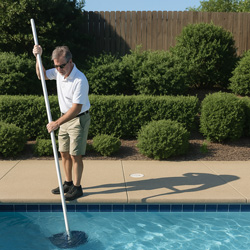 Father and son smiling at camera swimming underwater with swim goggles on