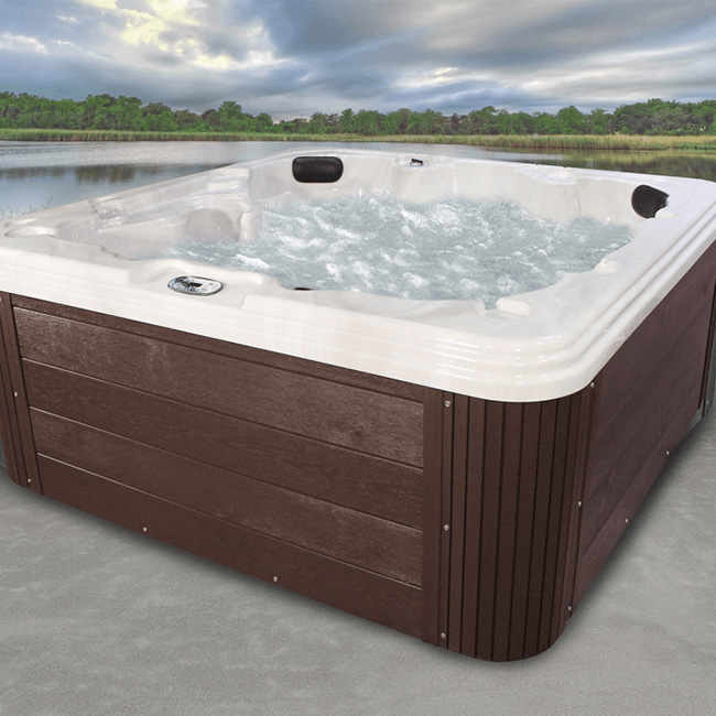 Embark series spa, a mid-range offering, shown on a patio overlooking freshwater lake